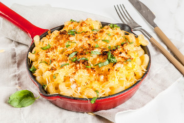 Mac and cheese, american style macaroni pasta with cheesy sauce and crunchy breadcrumbs topping, in...