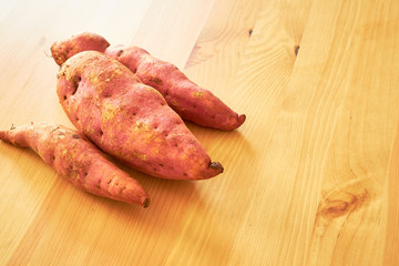 Sweet potatoes on a rustic wooden table