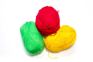 Yarn balls of different colors for knitting on a white background.