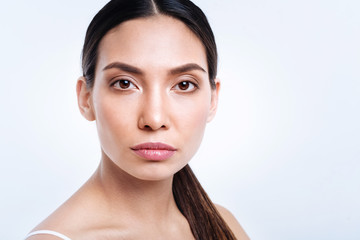 Portrait of attractive dark-haired woman with pony tail