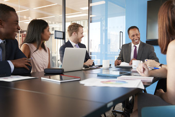 Young professional colleagues at business meeting, close up