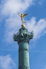 Fototapeta na wymiar Gilded statue Genie de la Liberte at July Column on Bastille Square. Place de la Bastille - square in Paris, where Bastille prison stood until 