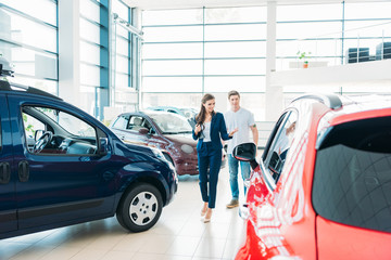 sales manager showing car to customer