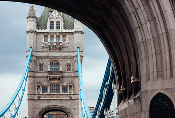 On Tower Bridge, looking up, framed by a stone arch.
