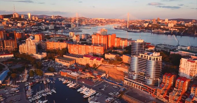 Aerial view of Egersheld peninsula, Vladivostok, Russia. The Golden Horn bay with Golden Bridge across it and the yacht club in Peter the Great Gulf (sea of Japan). Evening