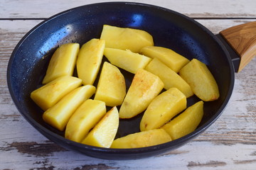 Fried potato in a frying pan. Step by step cooking