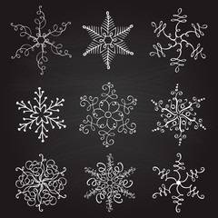 set of nine vintage vector illustration christmas snowflakes on chalkboard background. flourish calligraphic handmade