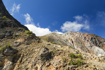 Hydrothermal gasses rise up and mix with late morning clouds near the summit of Mount Egon in East Nusa Tenggara, Indonesia.