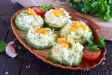 Grilled zucchini with cheese and garlic topping