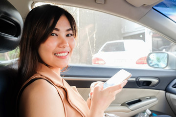 Sexy women use cellphone inside car