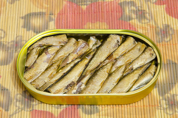 
Open metal can with sprats in oil.