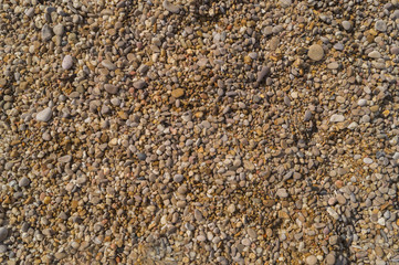 Small pebbles and sand as a background, texture