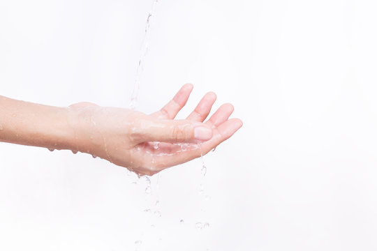The Asian girl's hands are splashed with water on white background