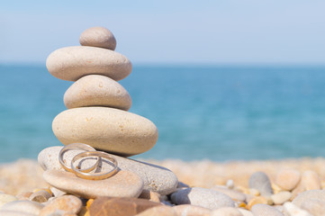 Pebble tower standing on the left on the sea beach