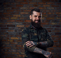Fototapeta premium Tattooed bearded male in military jacket.