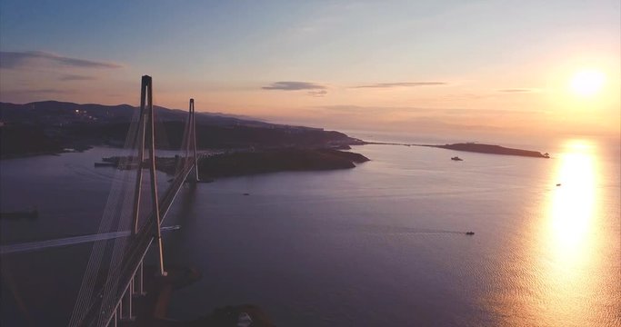 Great aerial view of the Russky Bridge, the world's longest cable-stayed bridge, and the Russky (Russian) Island in Peter the Great Gulf in the Sea of Japan. Sunrise. Vladivostok, Russia