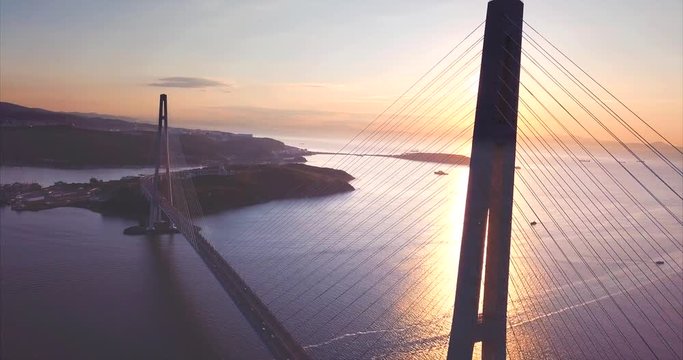 Amazing aerial view of the Russky Bridge, the world's longest cable-stayed bridge, and the Russky (Russian) Island in Peter the Great Gulf in the Sea of Japan. Sunrise. Vladivostok, Russia