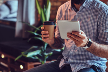 A man using tablet PC in a room.