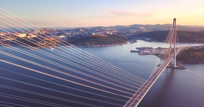 Flying above the Russian Bridge, the world's longest cable-stayed bridge built across the Eastern Bosphorus strait. Russian island and Vladivostok are on the background. Aerial. Russia