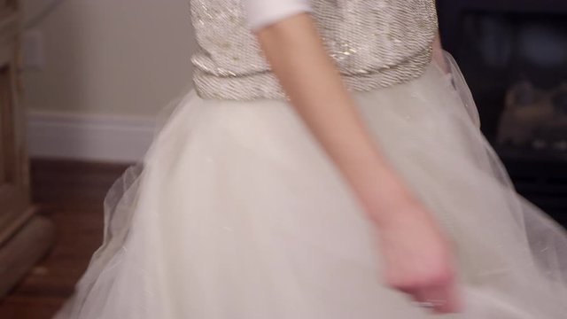 Woman twirling her skirt at a Holiday/Christmas party, pan