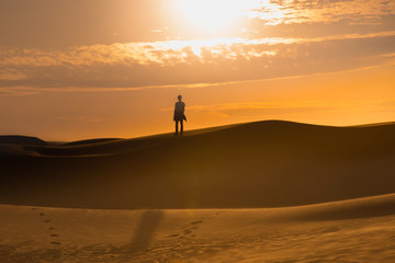 Two human silhouette in the sand desert 