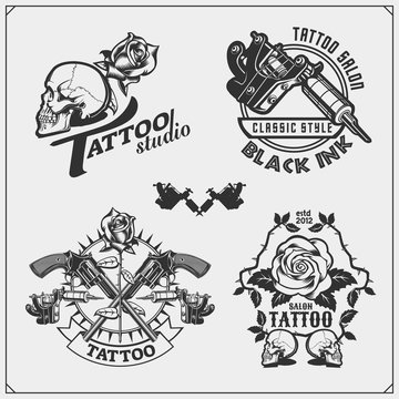 Vector set of tattoo salon labels, badges and design elements. Tattoo studio emblems with professional equipment, rose, gun and skull.