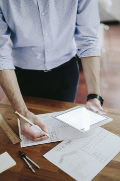 Young businessman working in office with digital tablet