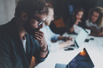 Businessman working together with project team at meeting room at night office.Horizontal.Blurred...