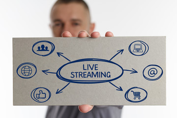 The concept of business, technology, the Internet and the network. Young businessman showing inscription: Live streaming