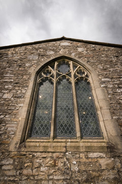 Church window with authentic gothic style and lights inside