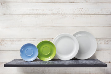 plate at shelf on white wooden background