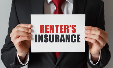Businessman holding a card with text Renter's insurance