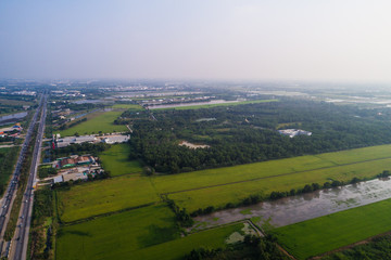 Fototapeta na wymiar Aerial vew of rural road with car and gree tree into th west region of Thailand