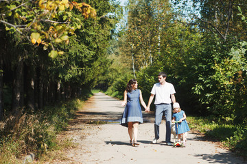 Fototapeta premium happy family with pet dog at picnic in a Sunny summer day. pregn