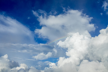 Rainbow in the clouds, which under clear skies a day.