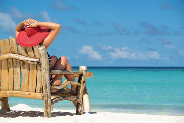 Young beautiful woman enjoying summer vacation, beach relax, summer in tropics