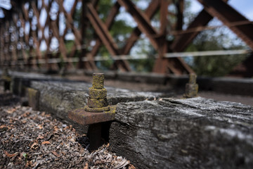 Closeup of old wooden sleepers with rusty screws but not rails
