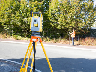 Civil Engineers At Construction Site and A land surveyor using an altometer Surveyor equipment...
