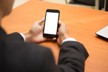 Businessman using his Mobile Phone outdoor, close up