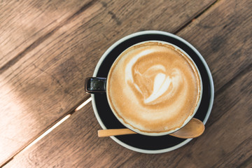 Coffee cup and coffee beans on wood table ,warm and good smell