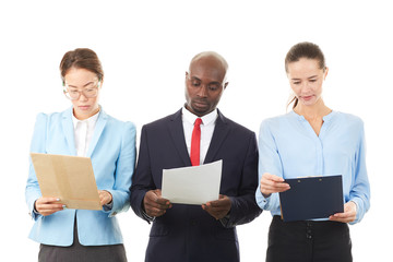 Portrait of confident multi-ethnic business team of three on white background