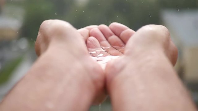 Enjoy the weather, the man filled the full ladle with rainwater. slowmotion, 1920x1080, HD
