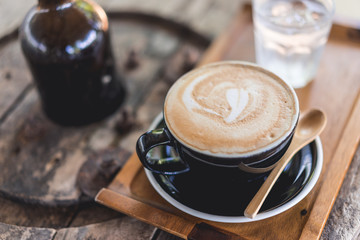 Coffee cup and coffee beans on wood table ,warm and good smell