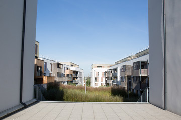 multi-family house in front of a blue sky seen of public park