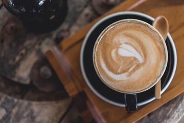 Coffee cup and coffee beans on wood table ,warm and good smell