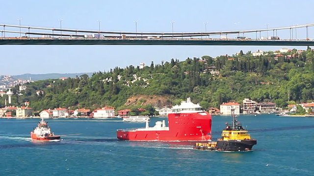 Towing Operation in Bosporus Straits. Towboat Amber II towing an offshore platform supply vessel in Istanbul. A 48 mt long, 15 mt width tugboat, launched into the
