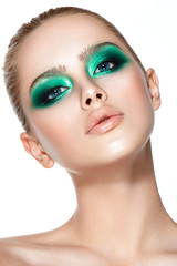 Fototapeta premium Beautiful woman portrait with green eyeshadows and perfect skin.
