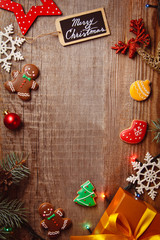 Beautiful Christmas background with gingerbreads, sweets and gift on wooden background. Merry Christmas postcard 2018