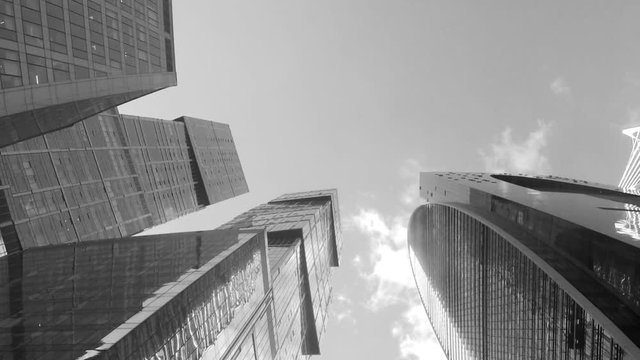 modern towers and sky with clouds black and white timelapse