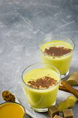 Natural cold and flu remedy, golden milk on stone background. Selective focus, space for text. 